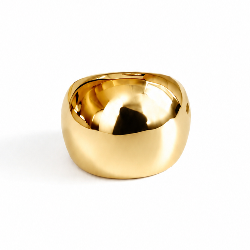 A polished gold-colored ring with a rounded, organic shape, photographed on a seamless white background.