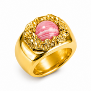 A gold signet-style ring featuring a round pink cabochon gemstone surrounded by a textured, scalloped gold bezel, set against a plain white background.